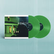 Green vinyl records with a cover featuring a silhouette of a person in front of a house.