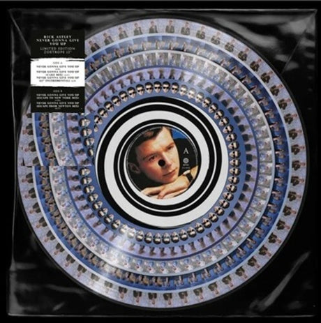Vinyl record with spiral design and portrait, surrounded by packaging