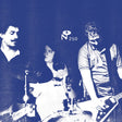 Black and white photo of a band performing with a logo in the corner