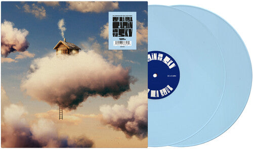 Vinyl record with a cloud and house design on the cover, set against a blue sky.