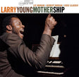 Album cover of 'Motherhip' by Larry Young featuring a musician playing piano with a raised fist.
