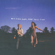 Two people standing in a field with a blue sky and trees, and text 'Never Before Seen, Never Again Found' above them.