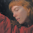 Person wearing a red jacket in a snowy setting