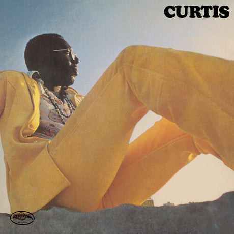 Album cover with a person in a yellow jacket against a blue sky, featuring the word 'CURTIS'.