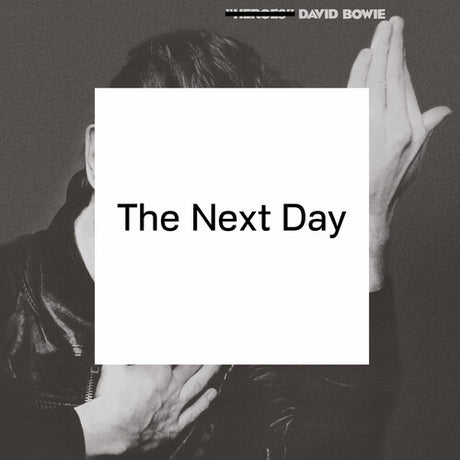 Album cover of 'The Next Day' by David Bowie with a black and white photo of a person holding their hands together.