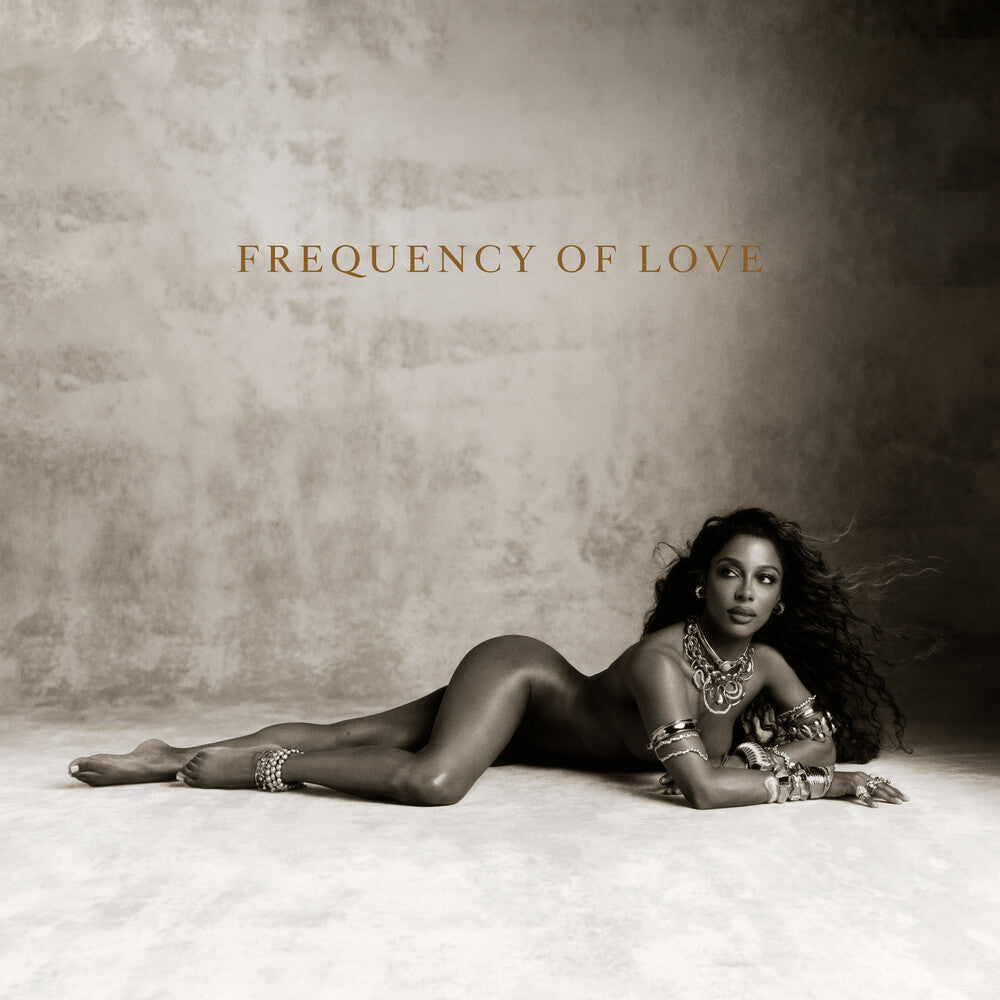 Album cover art for 'Frequency of Love' featuring a woman in a black bodysuit and silver jewelry lying on a textured beige floor against a matching beige wall.