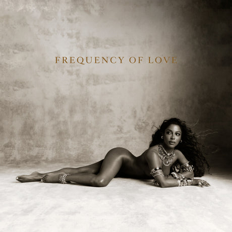 Album cover art for 'Frequency of Love' featuring a woman in a black bodysuit and silver jewelry lying on a textured beige floor against a matching beige wall.