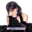 A stylized portrait of a woman with dark hair and bangs, wearing a black sleeveless dress and long black gloves, with rings on her fingers, against a white background. The word 'Pope' appears in a metallic stylized font at the bottom.