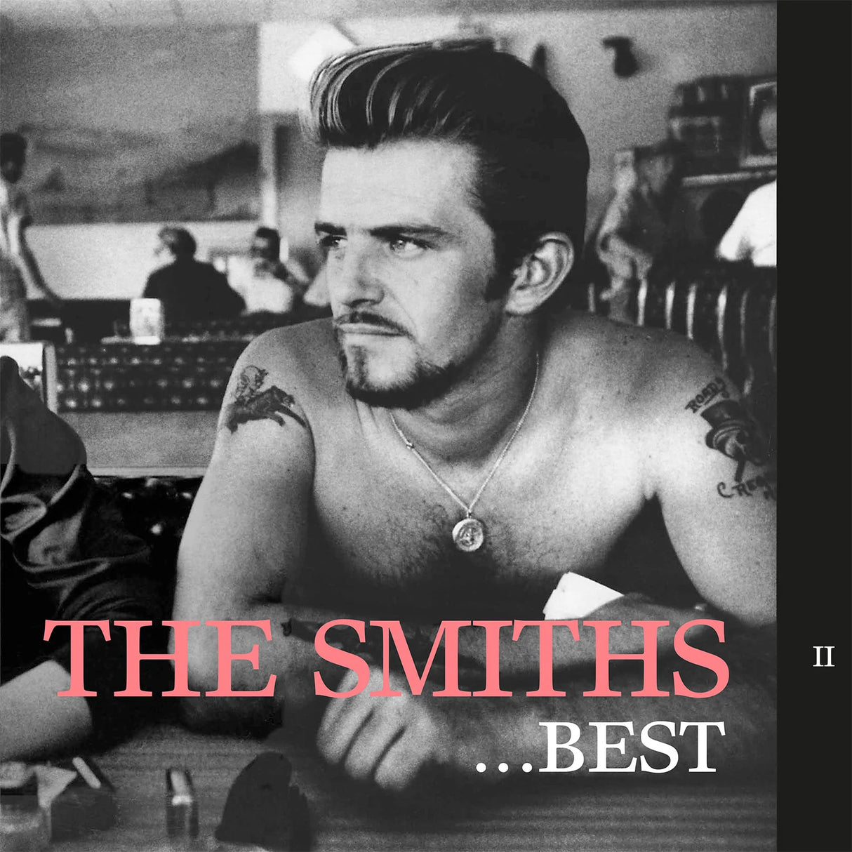 Album cover art for 'The Smiths - Best', featuring a black and white photograph of the band members, with the title in pink and white text at the bottom.