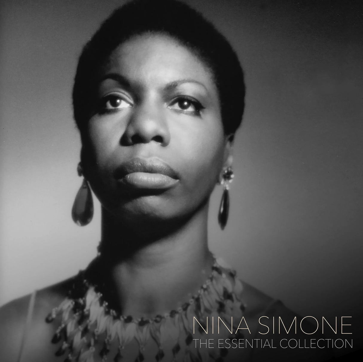 Black and white portrait of Nina Simone with text 'Nina Simone The Essential Collection' on a gray background