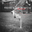Album cover art for 'Musical Chairs' by Hootie & The Blowfish, featuring a black and white photo of a person running barefoot across a grassy field, with the band's name and album title in white and red text.
