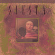 Album cover for 'Siesta' by Miles Davis and Marcus Miller with a textured background and portrait of a person.