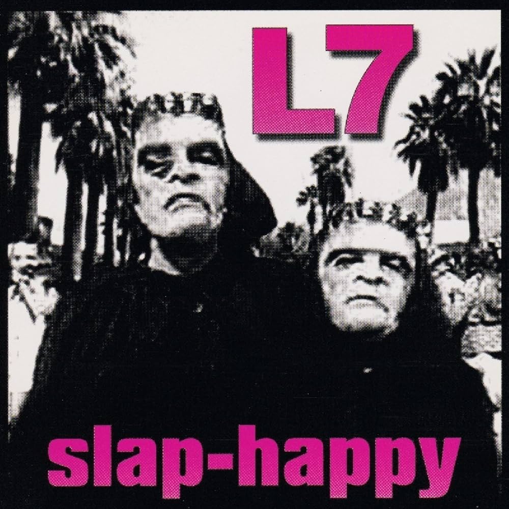 Album cover with two figures in black hoodies and pink 'L7' text on a palm tree background.