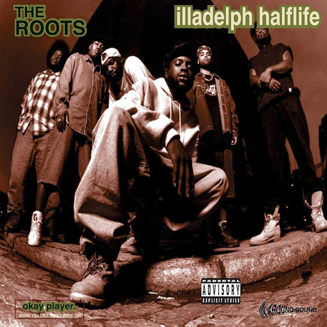 Album cover for 'illadelph halftime' by The Roots featuring a group of people on a street.