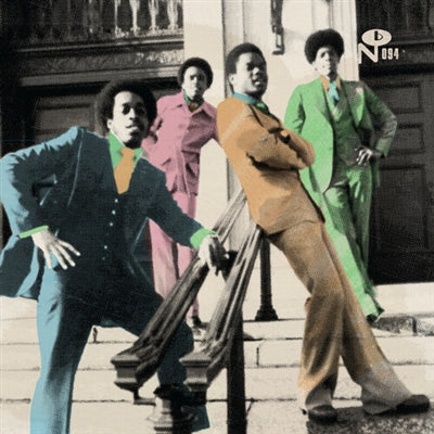 Album cover art for 'N'084' featuring four men in colorful suits posed on stone steps in front of a building entrance. The suits are blue, pink, tan, and green, with a black-and-white architectural background.