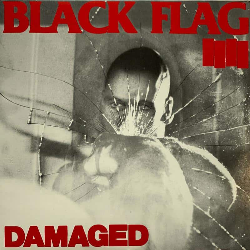 Album cover for 'Damaged' by Black Flag with a shattered glass effect and black and white image.