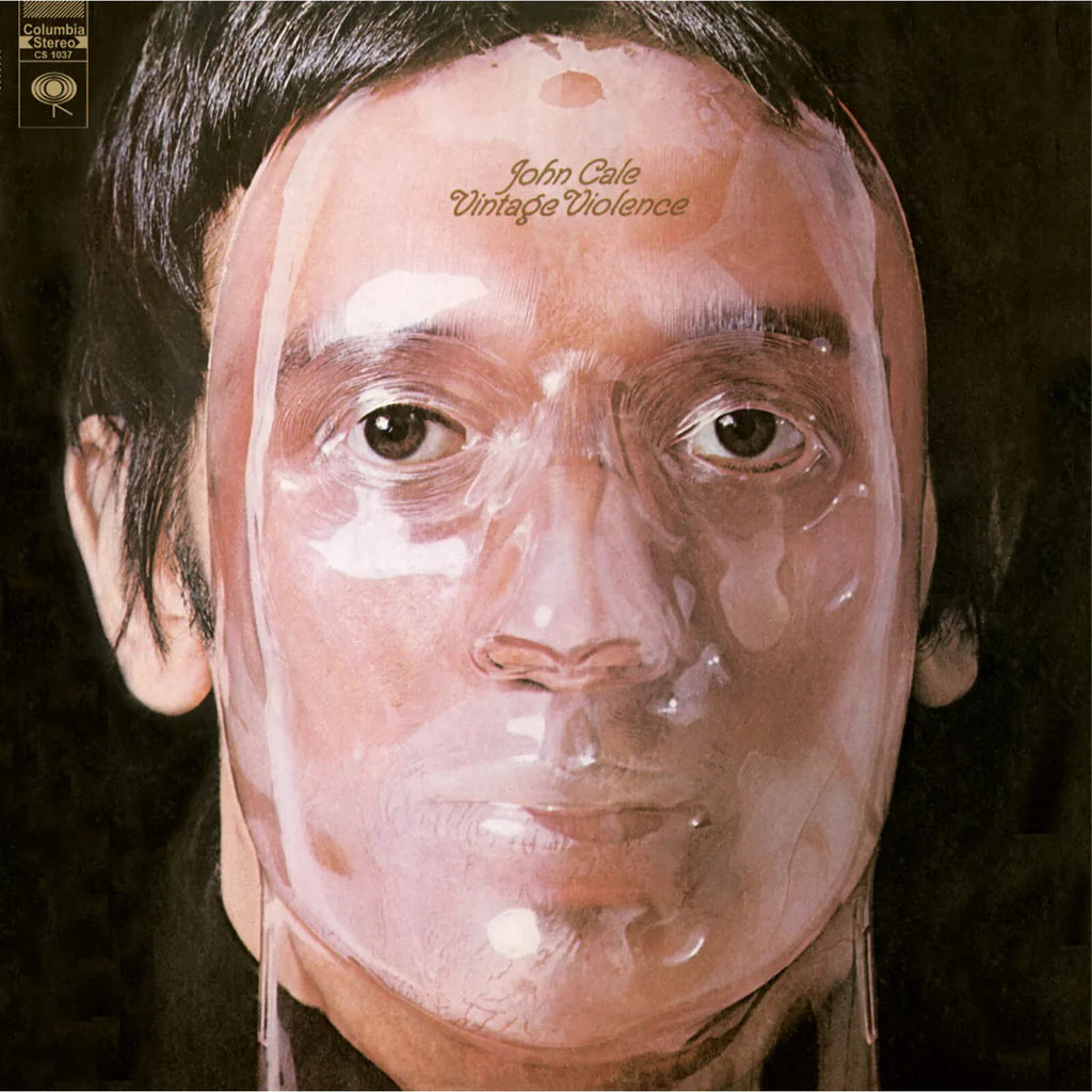 Album cover with a person's face partially covered by a clear plastic sheet, with text on the forehead.