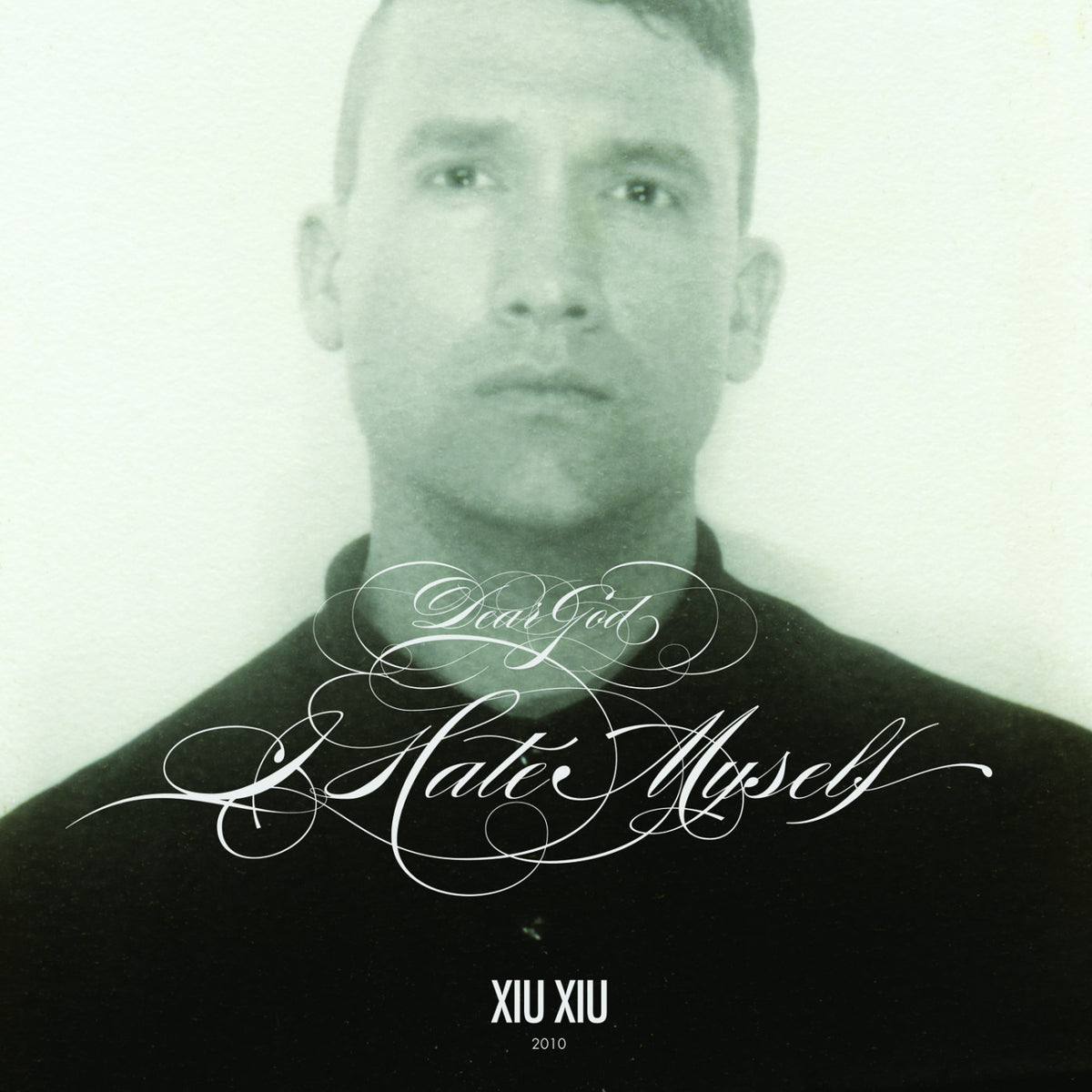 Album cover with a stylized text design and a person's face.
