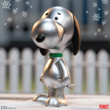 Metallic Snoopy figurine with snowflake decorations in the background
