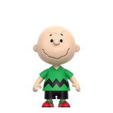 Toy figure of a character wearing a green shirt with black zigzag pattern and red shoes on a white background