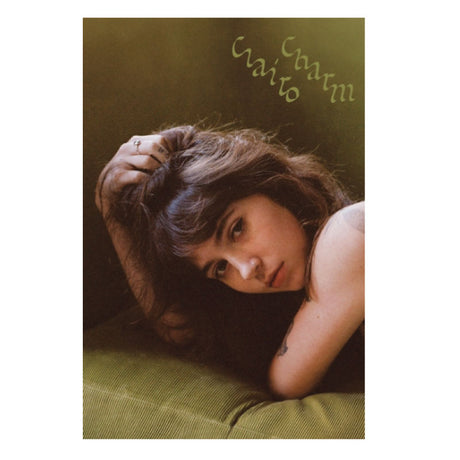 Album cover with a person lying down, text at the top, and a green background.