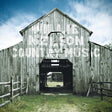 Wooden barn with text overlay on a blue sky background