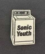 Embroidered patch of a washing machine with 'Sonic Youth' text on a dark background