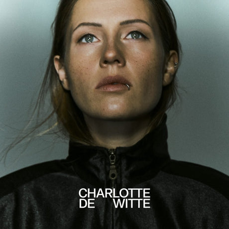 Woman wearing a dark jacket with 'Charlotte de Witte' text overlay