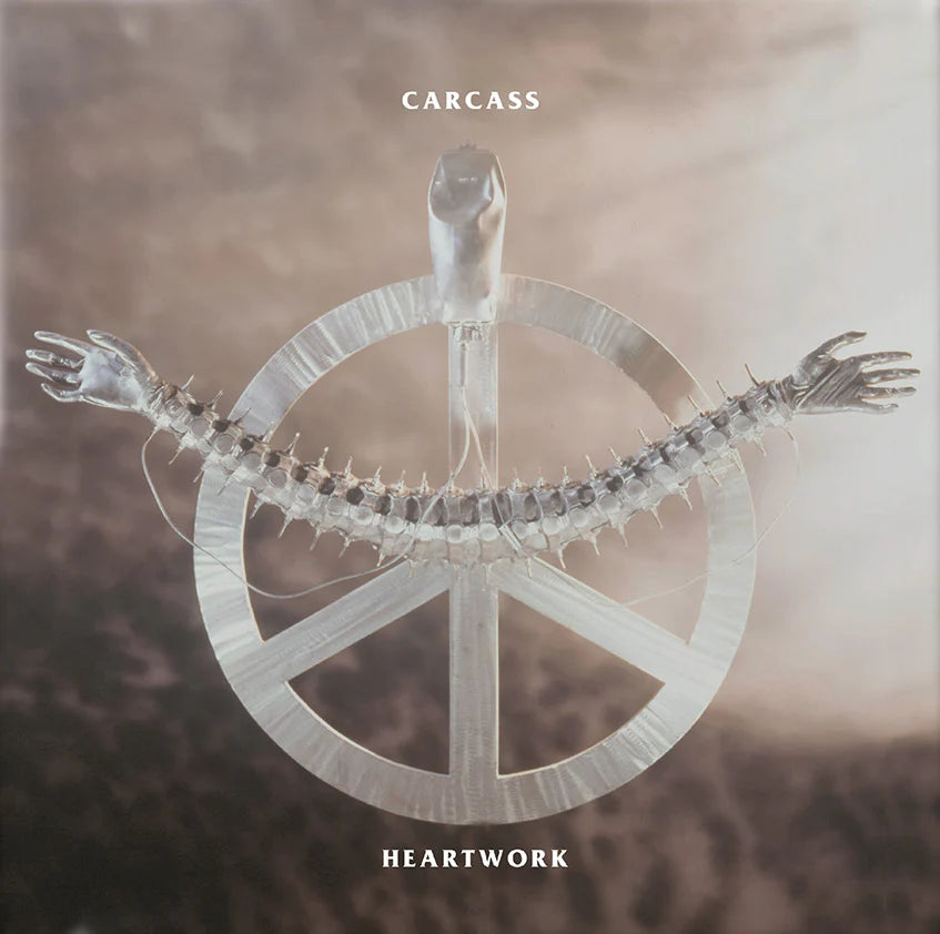 Album cover for 'Heartwork' by Carcass with a central symbol and text.