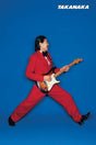 Person in a red suit playing an electric guitar against a blue background with 'Takanaka' branding.