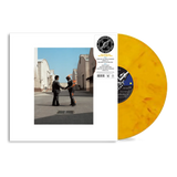 Vinyl record with a yellow disc and cover showing two people shaking hands on a street.
