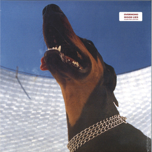 A vinyl record titled 'Overmono - Good Lies LP' featuring a close-up photograph of a dog's face, specifically a Doberman Pinscher, with a blue sky in the background.