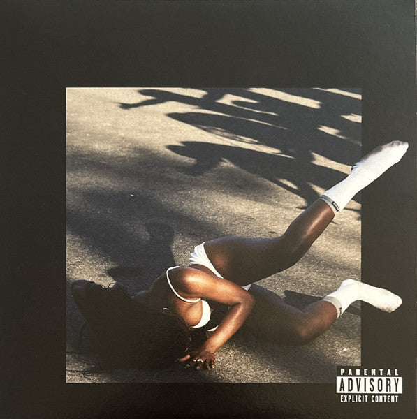 Album cover with a person in a sports outfit on a road, featuring a 'Parental Advisory' label.