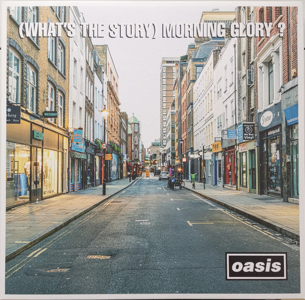 Album cover of 'What's the Story Morning Glory?' by Oasis featuring a city street scene.
