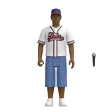 A stylized 3D-rendered baseball player figure wearing a white jersey with red and navy trim and script lettering, blue shorts, a blue cap with red trim, and white sneakers. A separate microphone accessory appears to the right on a plain white background.