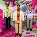 Three action figures of De La Soul members on a colorful background with 'De La Soul' text above.