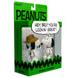 Peanuts figurine packaging with Snoopy and a friend, featuring a green border and 'Peanuts' branding.