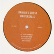A circular orange vinyl record label with white text reading 'DAMIAN'S GHOST UNIVERSALIS' and track listing details, photographed against a plain white background.