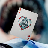 Playing card with shark design on a blurred background