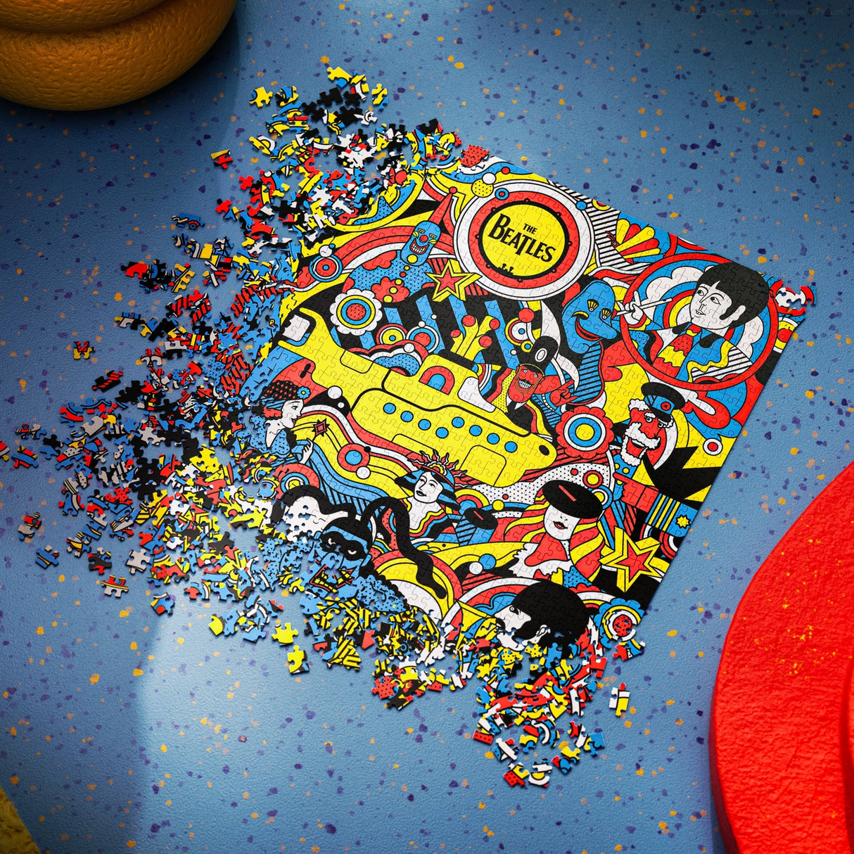 Puzzle of The Beatles album cover with pieces scattered on a blue background