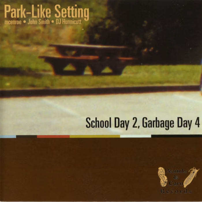 Album cover for 'Park-Like Setting' by John Smith and DJ Hunnicutt, featuring a faded photo of a picnic bench in a park, with the text 'School Day 2, Garbage Day 4' and a brown block at the bottom containing the 'Panics & Confuses Records' logo.
