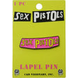 A 'Sex Pistols' lapel pin displayed on its original lime green backing card. The pin features the band's name in yellow with a dripping black outline on a pink background.