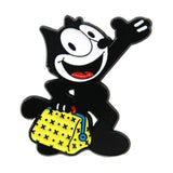 A cartoon enamel pin of a waving black cat holding a yellow patterned purse, isolated on a white background.