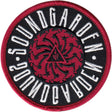 A circular embroidered patch featuring the text 'SOUNDGARDEN' in white around a red spiral motif on a black background, with a red stitched border.