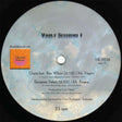 Vinyl record label with text and branding on a light gray background