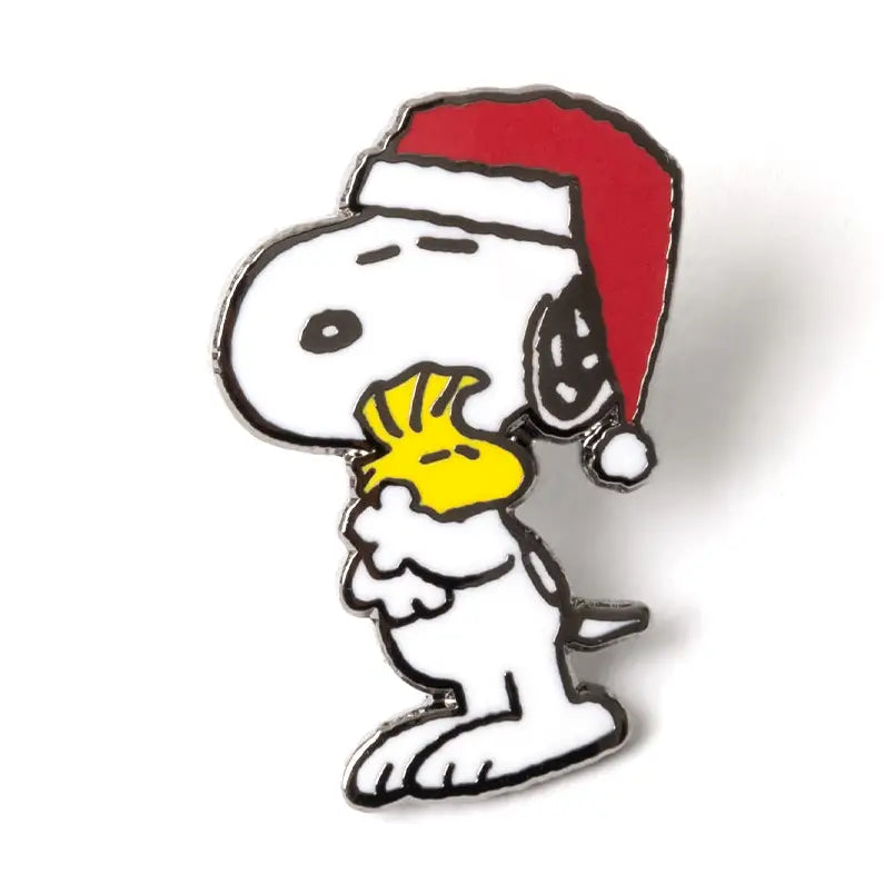 Snoopy wearing a Santa hat with a yellow handkerchief on a white background