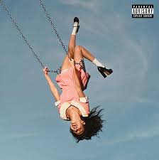 Person swinging high above the ground against a clear blue sky