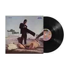 Vinyl record album shown with the front cover and one black record partially pulled out. The cover features Willie Colon with the title 'para tu vida' and 'mujer' on a city waterfront scene.