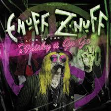 Album cover art for Enuff 'Znuff' titled 'Live in the Muddy & Go Go', featuring a stylized portrait of the artist with long yellow hair, black clothing, and a microphone, surrounded by purple and green graphic elements.