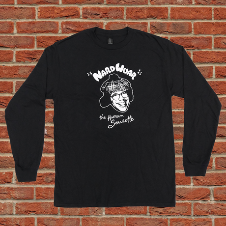 Black long-sleeve shirt with graphic design on a brick wall background